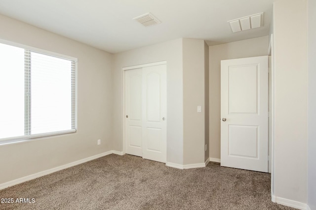 24479 W Mobile Ln, Buckeye, AZ 85326 - unfurnished bedroom with a closet, carpet floors, visible vents, and baseboards