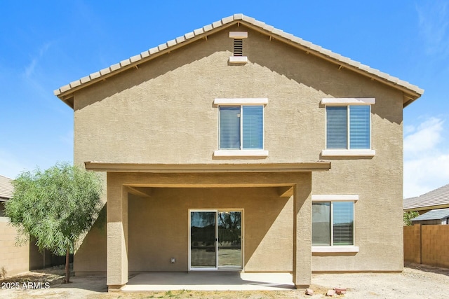 24479 W Mobile Ln, Buckeye, AZ 85326 - rear view of property with fence, a patio area, and stucco siding