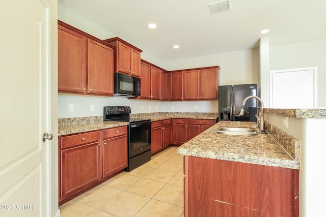 24479 W Mobile Ln, Buckeye, AZ 85326 - kitchen with a sink, light tile patterned flooring, visible vents, light countertops, and black appliances