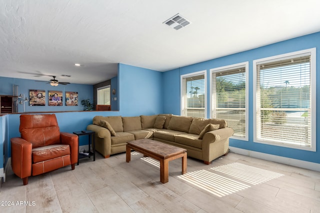 living room featuring ceiling fan and light hardwood / wood-style floors