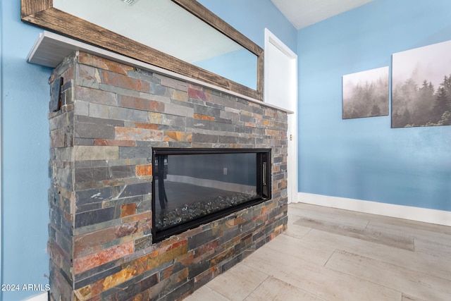 details featuring hardwood / wood-style floors and a fireplace