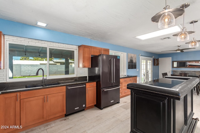 kitchen featuring french doors, sink, light wood-type flooring, tasteful backsplash, and stainless steel appliances