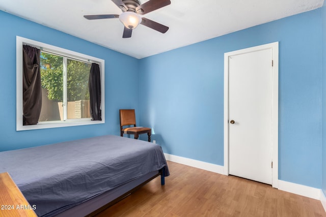 bedroom with ceiling fan and light wood-type flooring