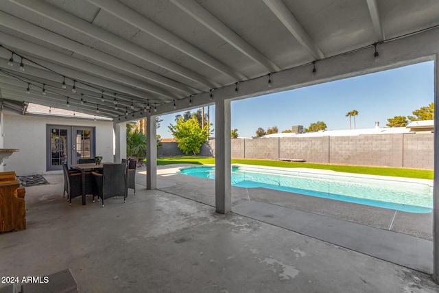 view of pool featuring french doors and a patio