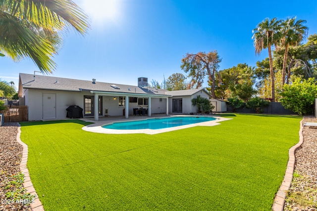 view of swimming pool featuring a patio area and a yard