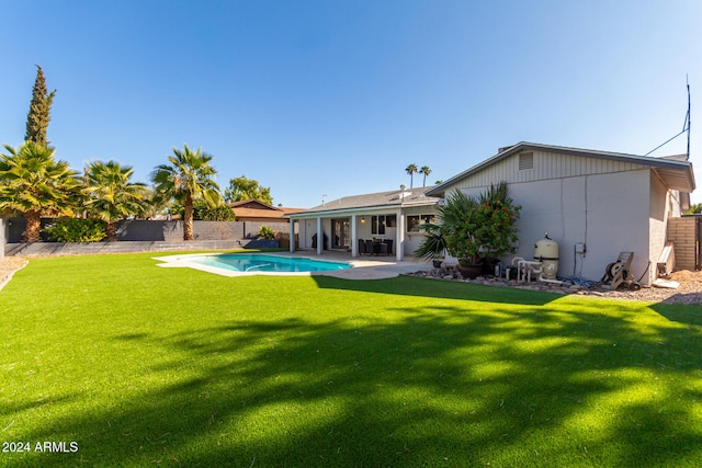 view of yard featuring a patio and a fenced in pool