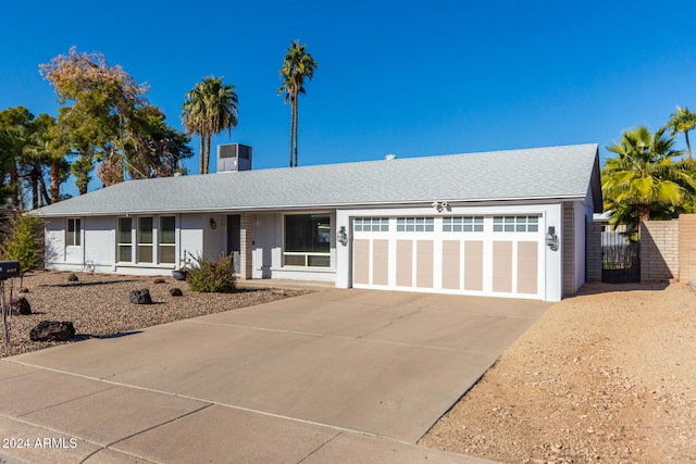 single story home with central AC and a garage