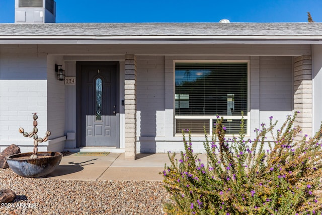 view of exterior entry with a porch