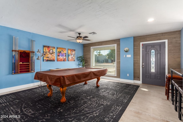 recreation room with ceiling fan, wood walls, pool table, and light hardwood / wood-style flooring