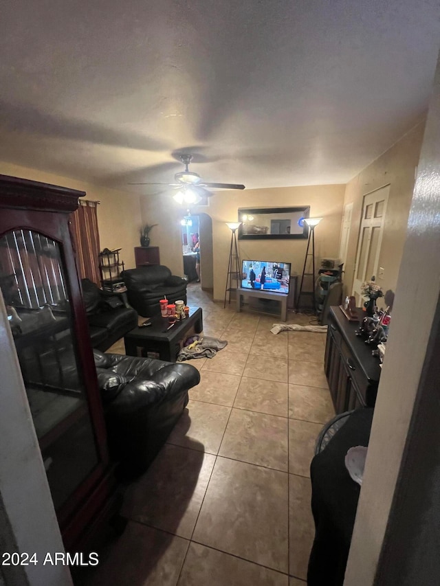 tiled living room featuring ceiling fan