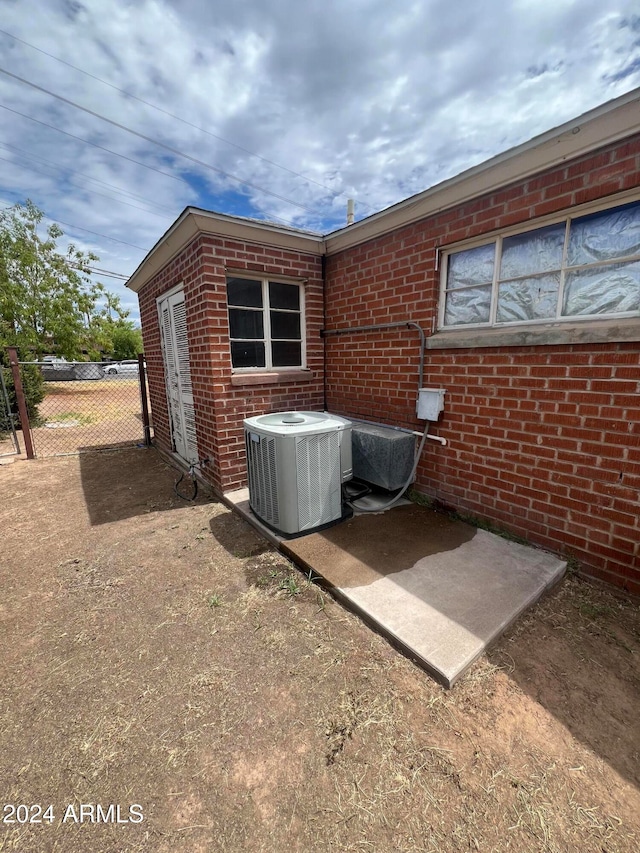 view of side of home with central air condition unit