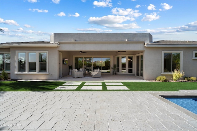 2821 E Cashman Dr, Phoenix, AZ 85050 - rear view of property with ceiling fan, a patio, an outdoor hangout area, and stucco siding