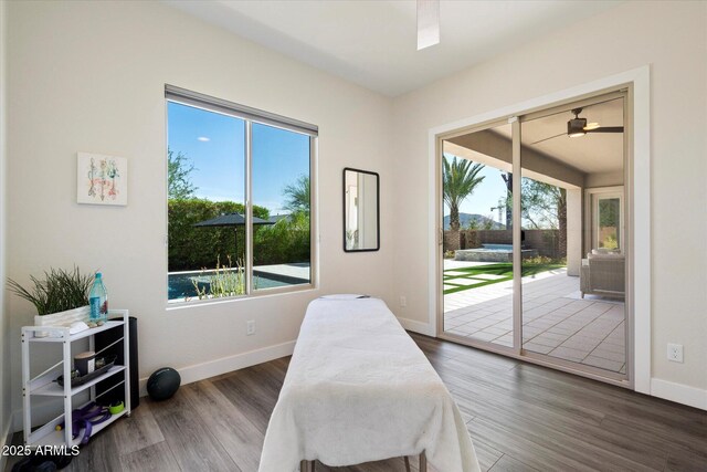 2821 E Cashman Dr, Phoenix, AZ 85050 - bedroom with access to outside, multiple windows, baseboards, and wood finished floors