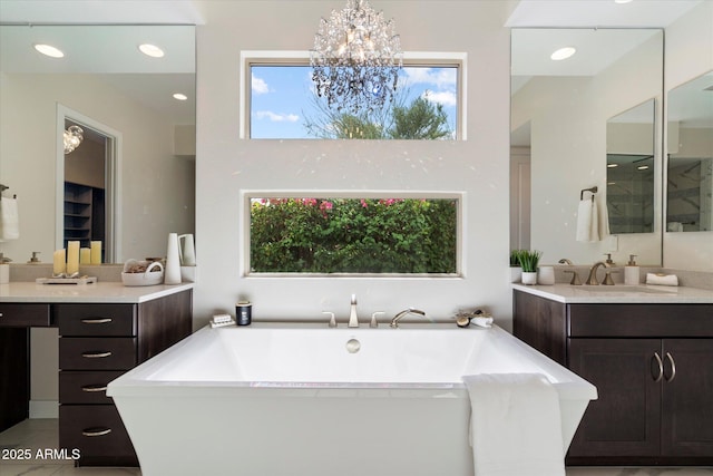 2821 E Cashman Dr, Phoenix, AZ 85050 - bathroom with a freestanding bath, a chandelier, vanity, and recessed lighting