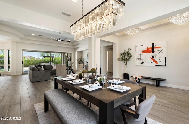 2821 E Cashman Dr, Phoenix, AZ 85050 - dining area with a chandelier, wood finished floors, baseboards, and a ceiling fan