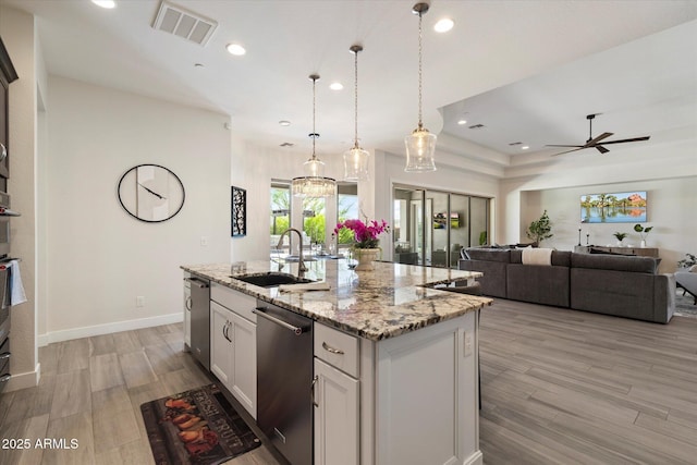 2821 E Cashman Dr, Phoenix, AZ 85050 - kitchen with a sink, stainless steel dishwasher, recessed lighting, a center island with sink, and open floor plan