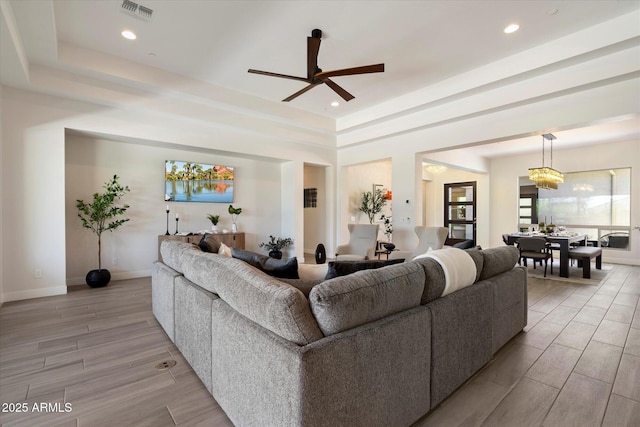 2821 E Cashman Dr, Phoenix, AZ 85050 - living room featuring wood finish floors, baseboards, a tray ceiling, and recessed lighting