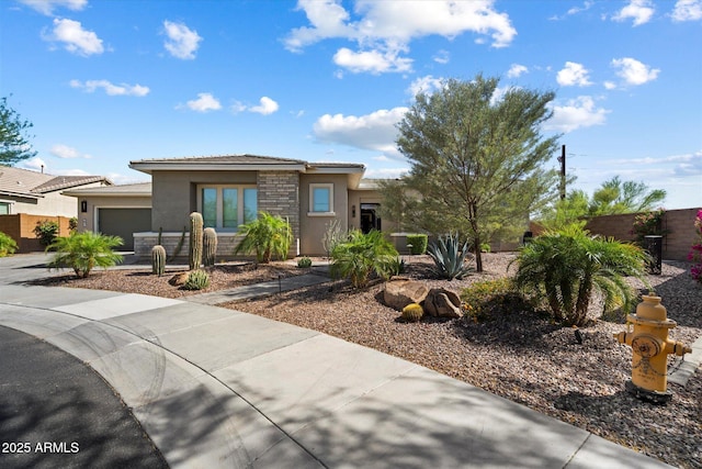 2821 E Cashman Dr, Phoenix, AZ 85050 - prairie-style house with stucco siding, an attached garage, a tiled roof, stone siding, and driveway