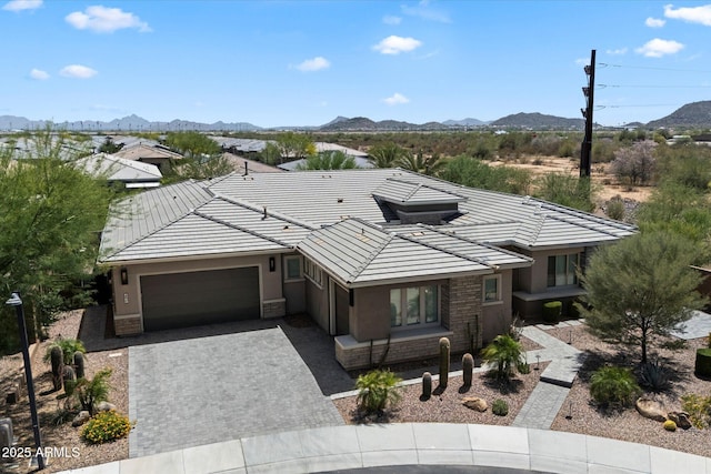 2821 E Cashman Dr, Phoenix, AZ 85050 - view of front facade with an attached garage, a mountain view, stucco siding, decorative driveway, and a tile roof