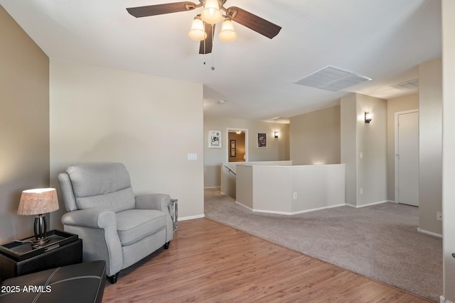 living area with ceiling fan and light wood-type flooring