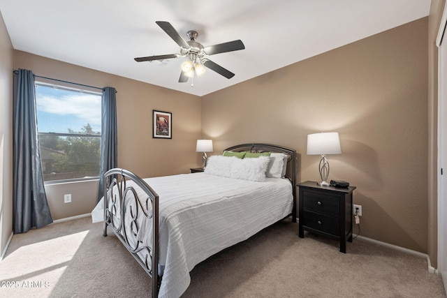 bedroom with light colored carpet and ceiling fan