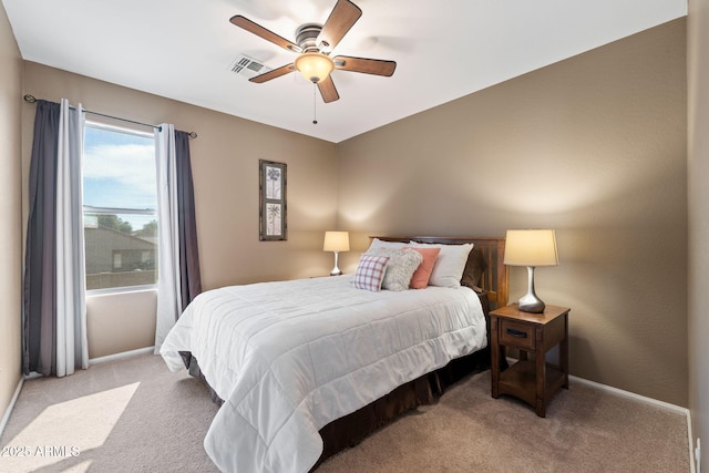 bedroom featuring ceiling fan and light carpet