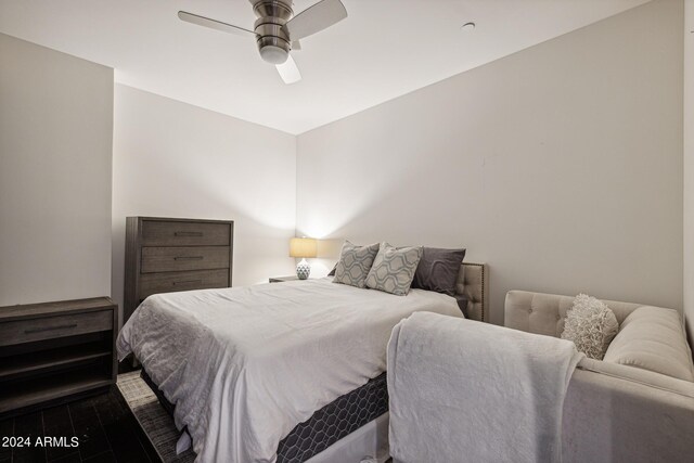 bedroom featuring ceiling fan and dark wood-type flooring