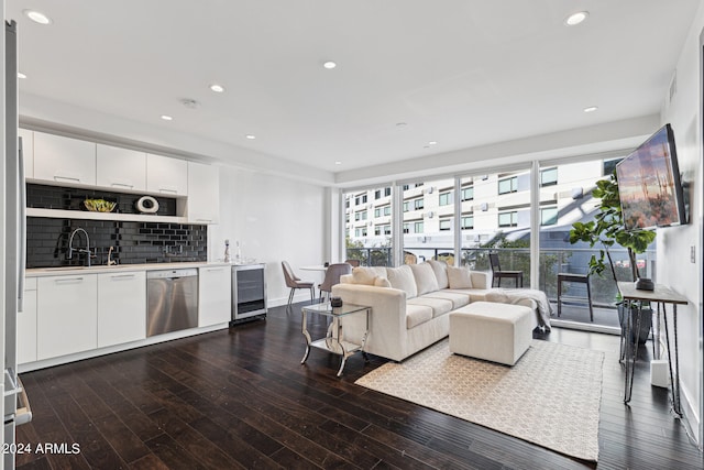 living room with wet bar, dark hardwood / wood-style flooring, and wine cooler