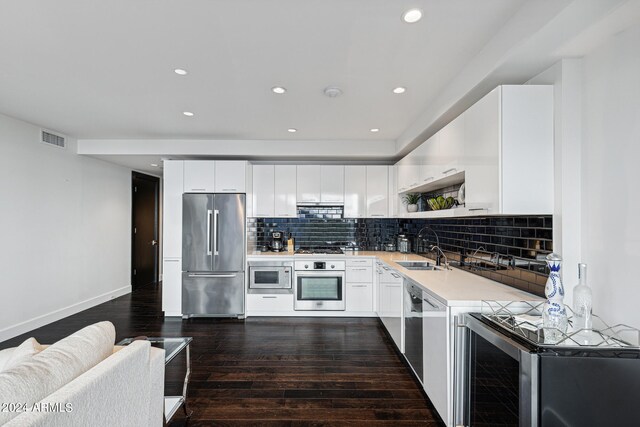 kitchen featuring stainless steel appliances, white cabinets, and dark hardwood / wood-style floors