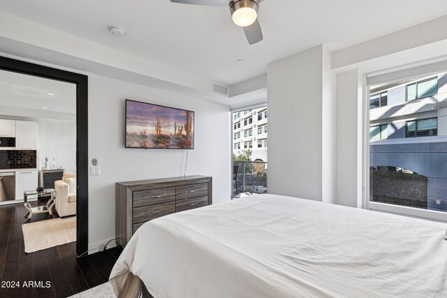 bedroom with multiple windows, dark hardwood / wood-style floors, and ceiling fan