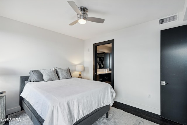 bedroom with ceiling fan, dark hardwood / wood-style floors, and ensuite bathroom