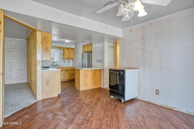 kitchen with hardwood / wood-style flooring, ceiling fan, light brown cabinetry, kitchen peninsula, and stainless steel refrigerator