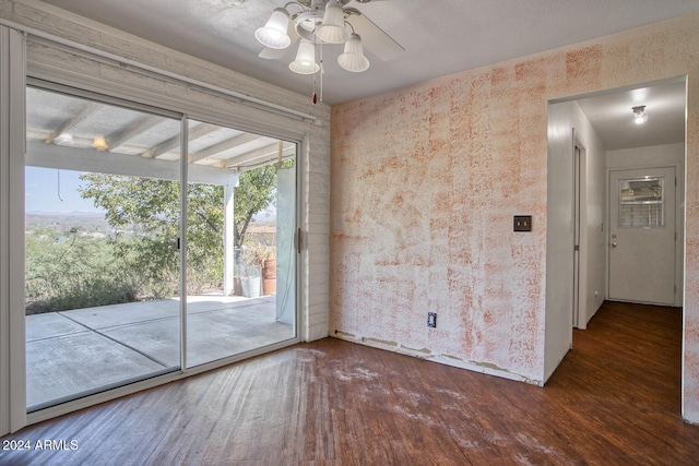 spare room featuring ceiling fan and dark hardwood / wood-style floors