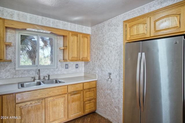 kitchen featuring stainless steel refrigerator, sink, and dark hardwood / wood-style flooring