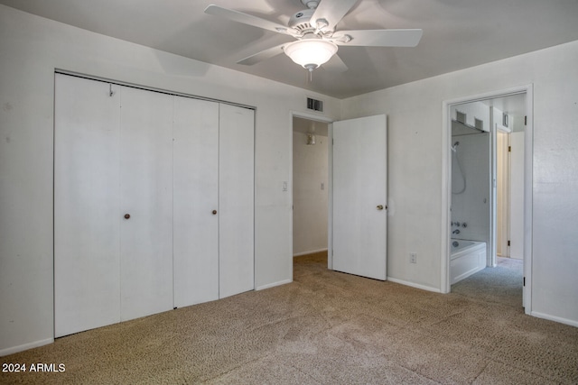 unfurnished bedroom featuring light carpet, ensuite bath, and ceiling fan