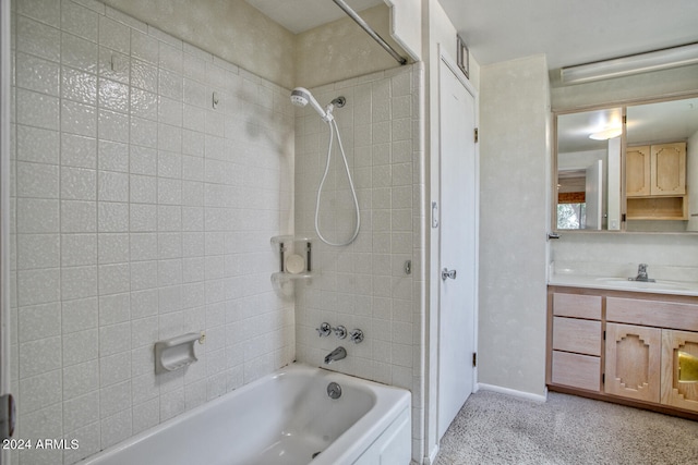 bathroom featuring tiled shower / bath combo and vanity