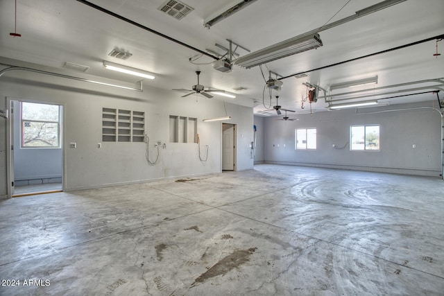 garage with ceiling fan and a garage door opener