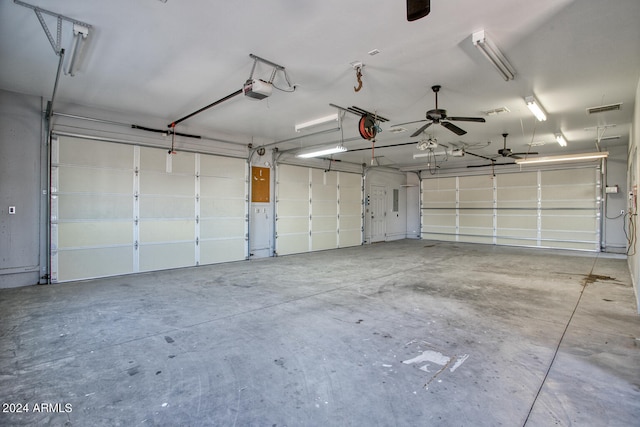 garage with a garage door opener and ceiling fan