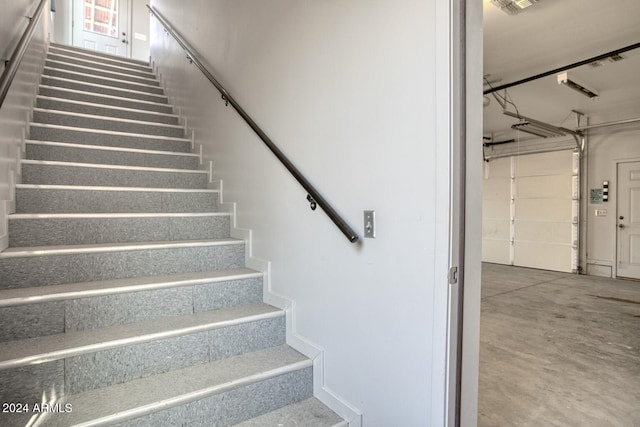 stairway featuring concrete floors