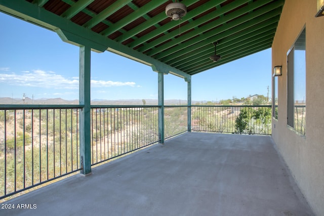 view of patio / terrace with a mountain view and a balcony