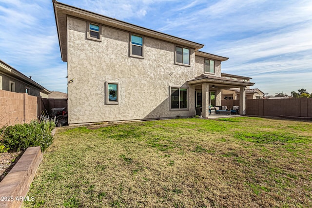 back of property featuring a patio area and a yard