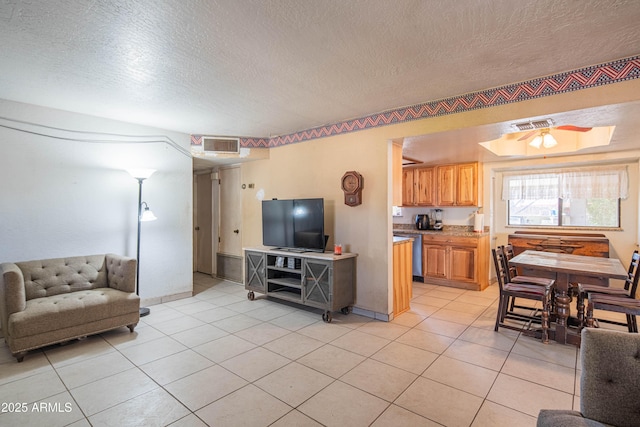 living room featuring a textured ceiling and light tile patterned flooring