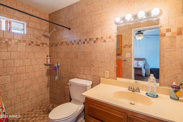 bathroom featuring vanity, toilet, and a tile shower