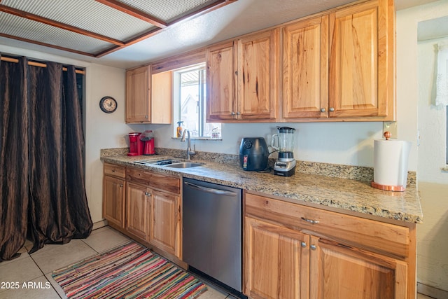 kitchen with dishwasher, light stone countertops, sink, and light tile patterned floors