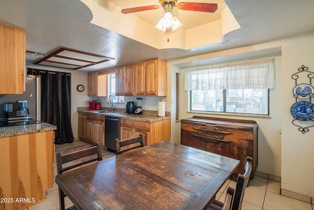 kitchen featuring light tile patterned flooring, plenty of natural light, stainless steel fridge, and black dishwasher