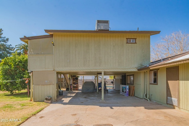 back of property with a carport and cooling unit