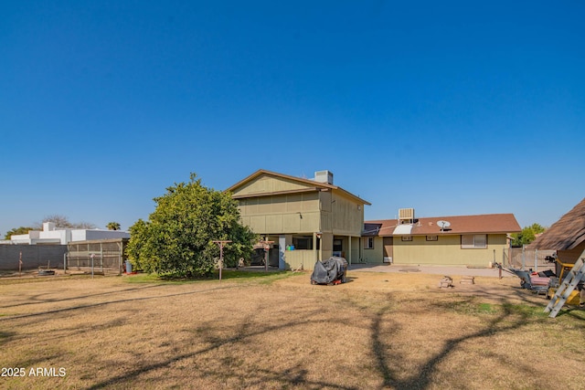 back of property featuring a yard