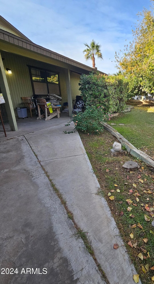 exterior space with a patio and a lawn