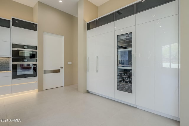 interior space featuring a mail area, white cabinetry, and double oven