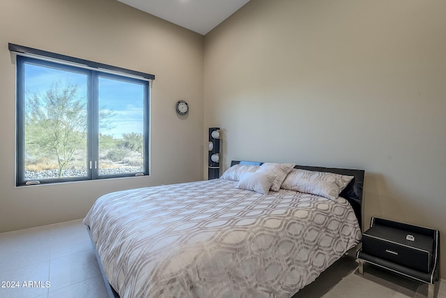 bedroom with multiple windows and light tile patterned flooring